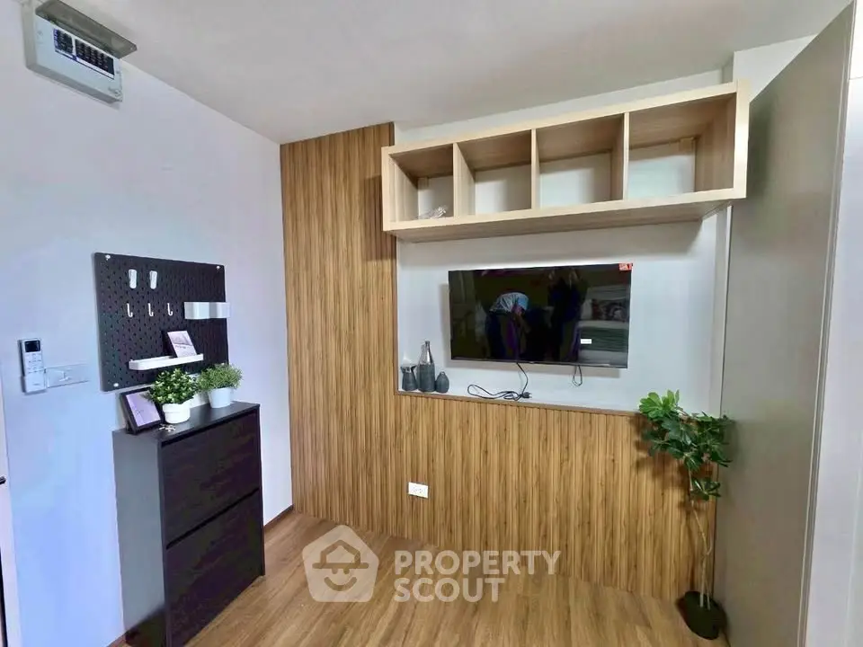 Modern living room with stylish wood paneling and mounted TV