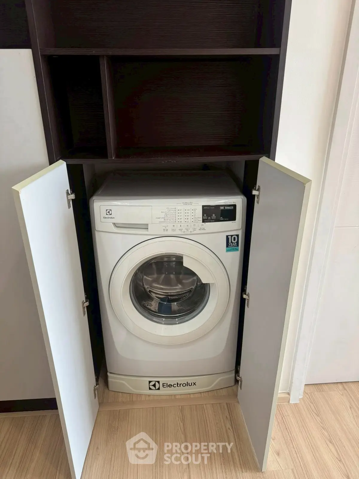 Modern Electrolux washing machine in sleek built-in cabinet, perfect for efficient laundry space in contemporary homes.