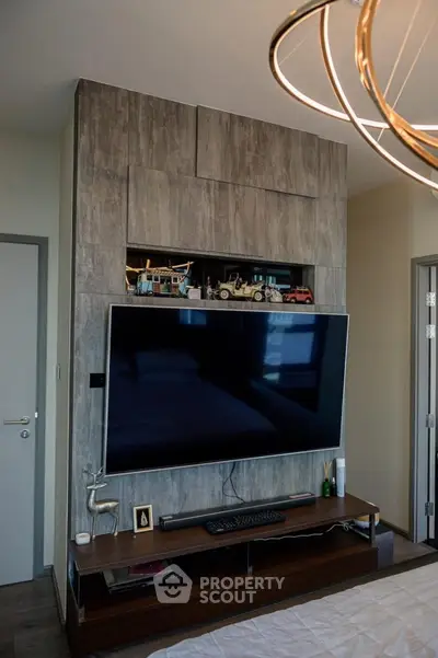 Modern living room with large flat-screen TV and stylish decor