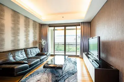 Luxurious living room with modern decor and large windows opening to a balcony.