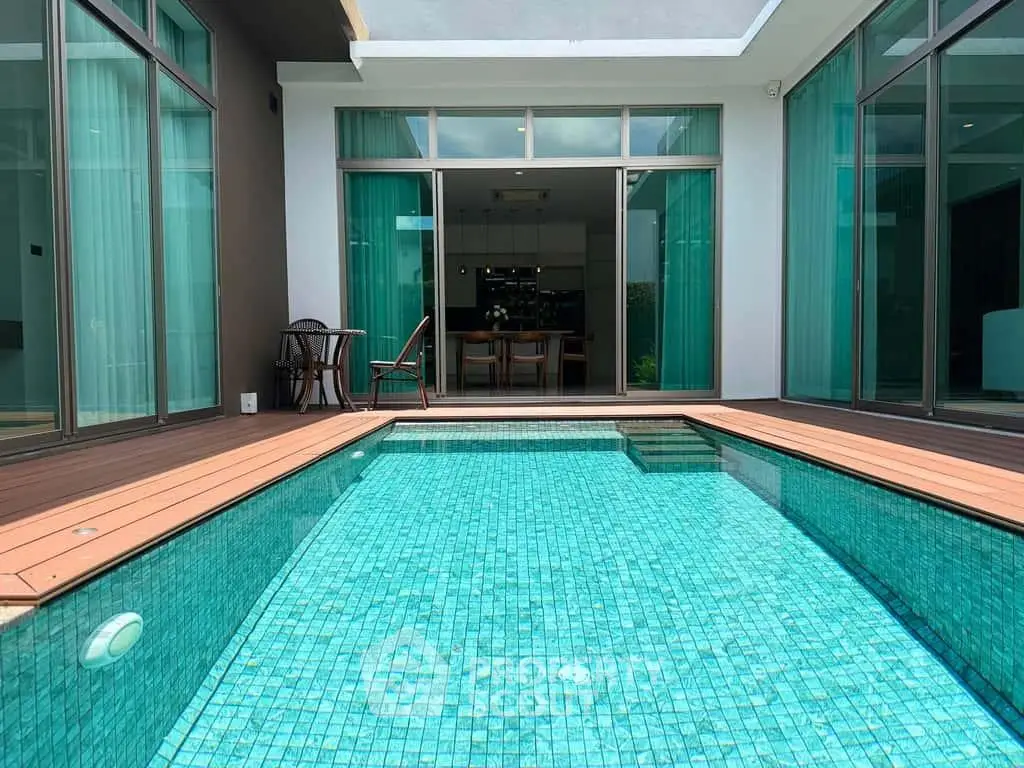Luxurious modern home with private pool and elegant glass doors leading to a stylish interior.