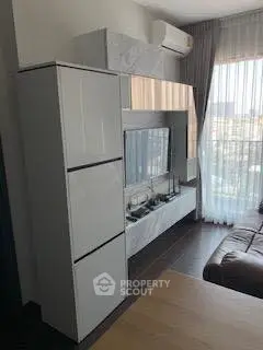 Modern living room with sleek furniture and large window view