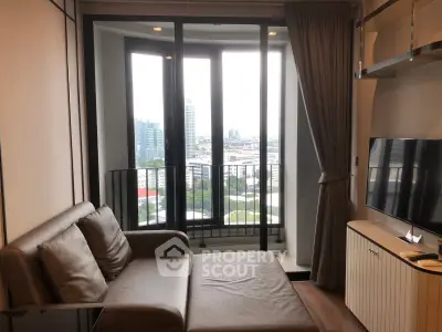 Modern living room with city view, featuring a cozy sofa and large windows for natural light.