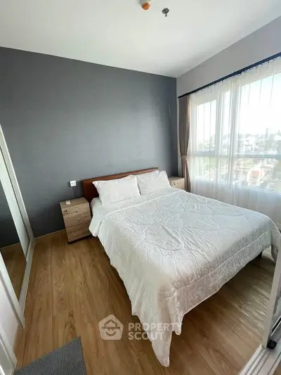 Bright and cozy bedroom with large windows and modern decor