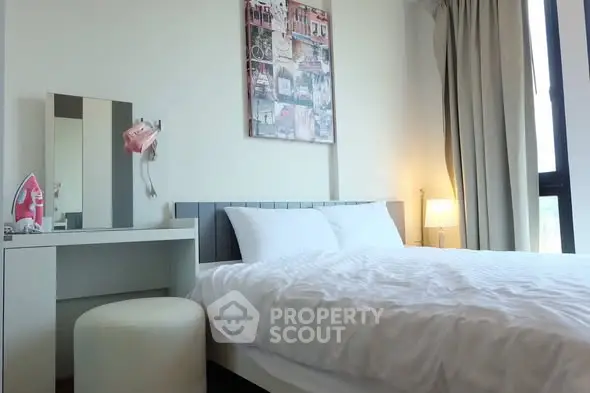 Cozy bedroom with modern decor and natural light, featuring a comfortable bed and stylish furnishings.