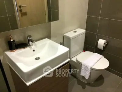 Modern bathroom with sleek fixtures and neutral tiles, perfect for a contemporary home.