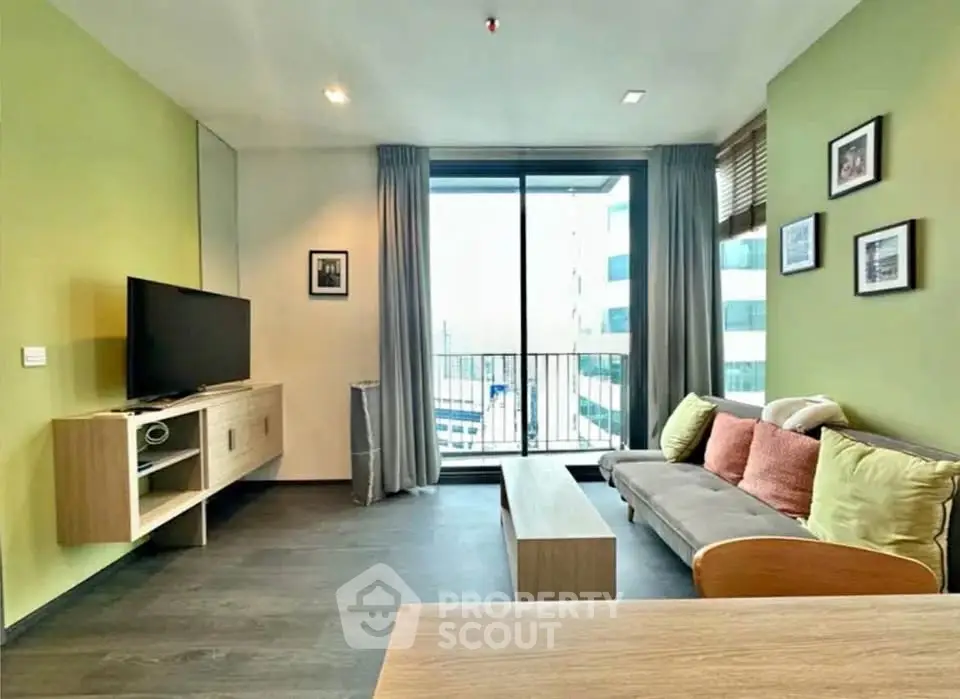 Modern living room with balcony view, stylish decor, and natural light