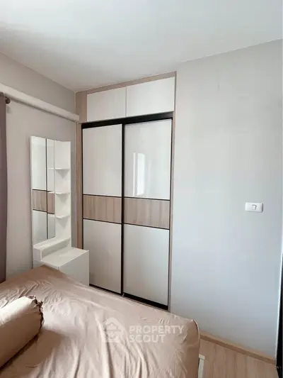 Modern bedroom with sleek sliding wardrobe and neutral decor
