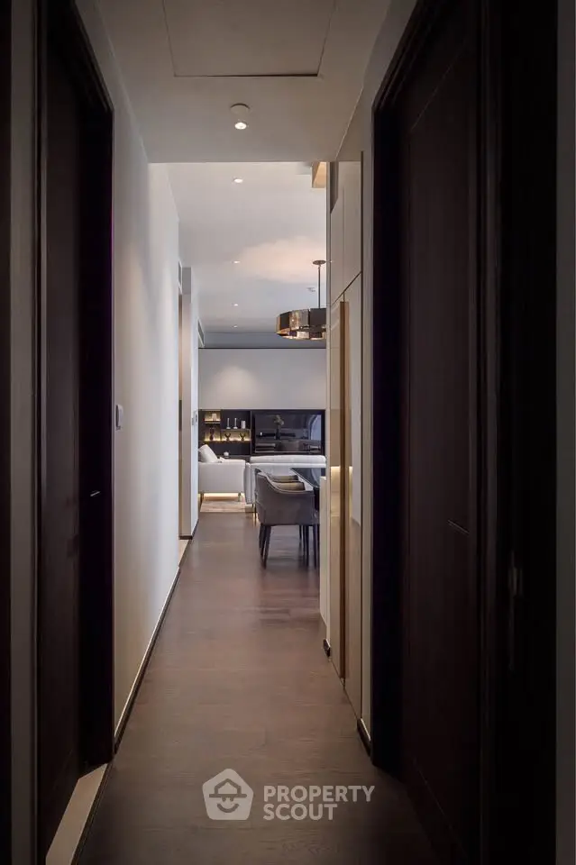 Elegant hallway leading to a modern living room with stylish decor and ambient lighting.