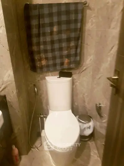 Compact bathroom with modern toilet and marble tiles