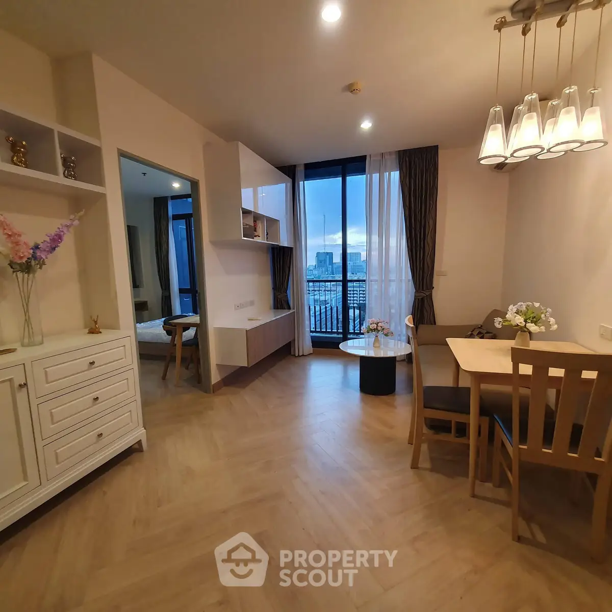 Modern living room with dining area and city view balcony in elegant apartment