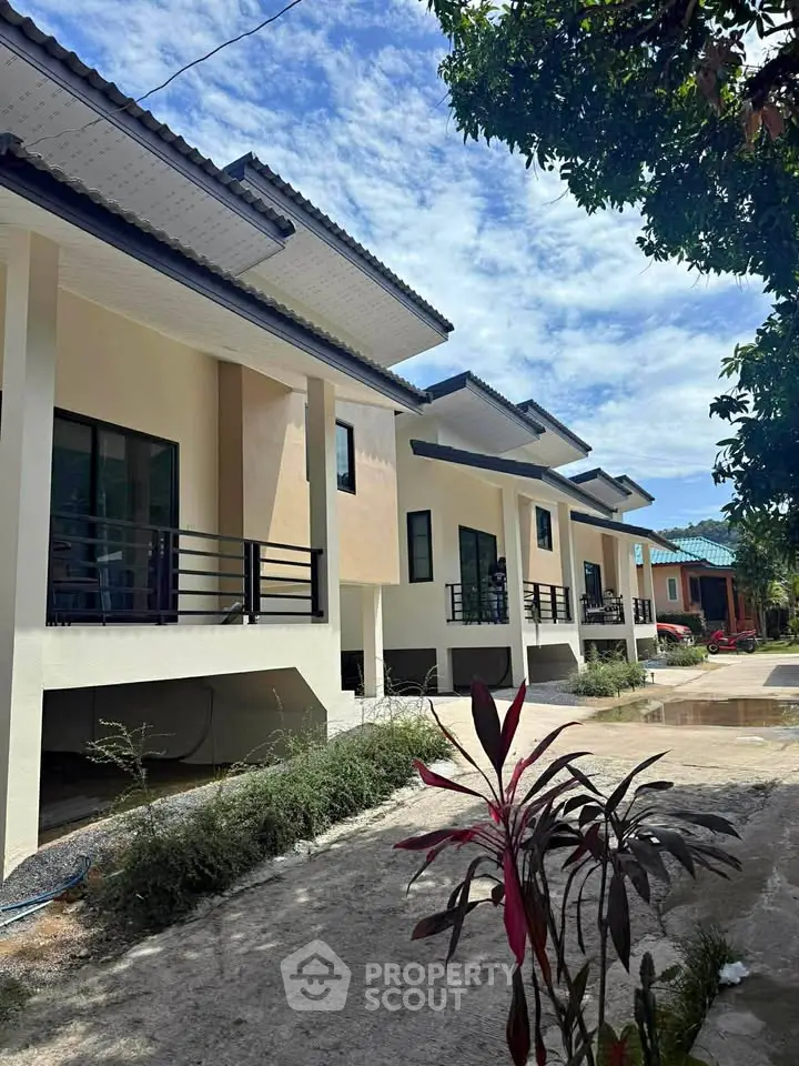 Modern row of elevated houses with sleek design and lush surroundings, perfect for serene living.