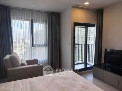 Modern bedroom with balcony and city view in high-rise apartment