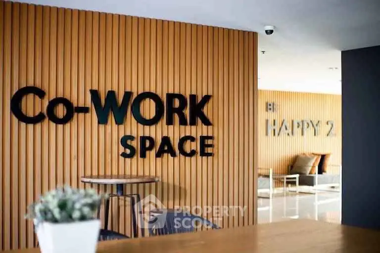 Modern co-working space with stylish wooden paneling and comfortable seating area.