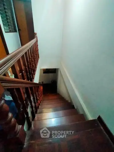 Elegant wooden staircase with classic railing in a cozy home interior