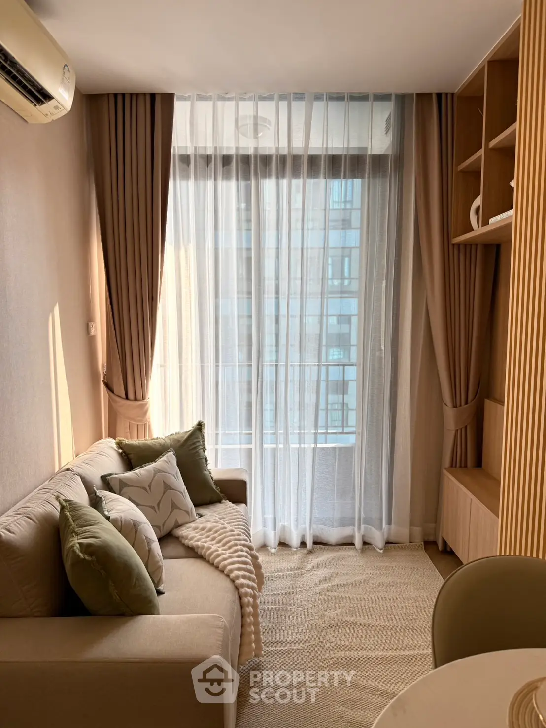 Cozy living room with modern decor and large window view