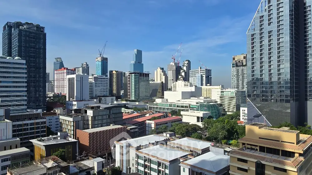 Stunning cityscape view of modern skyscrapers and urban skyline under clear blue sky.