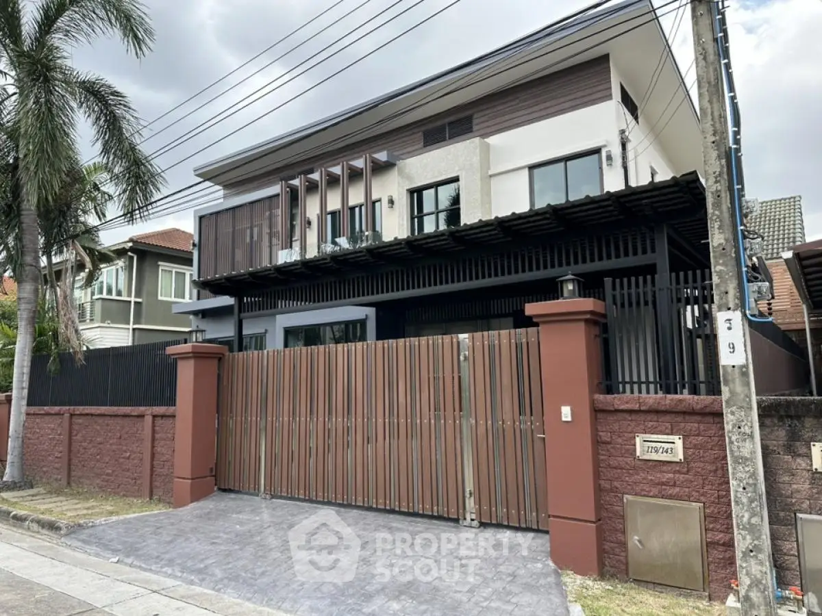 Modern two-story house with gated entrance and contemporary design