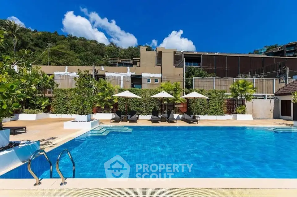Luxurious outdoor pool area with sun loungers and umbrellas, perfect for relaxation and leisure.