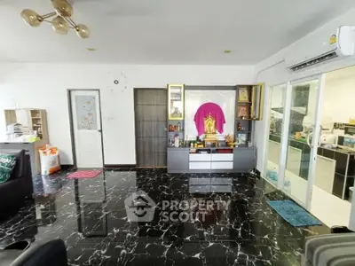 Spacious living room with marble flooring and modern decor in a stylish home.