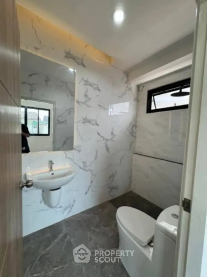 Modern bathroom with marble walls and sleek fixtures