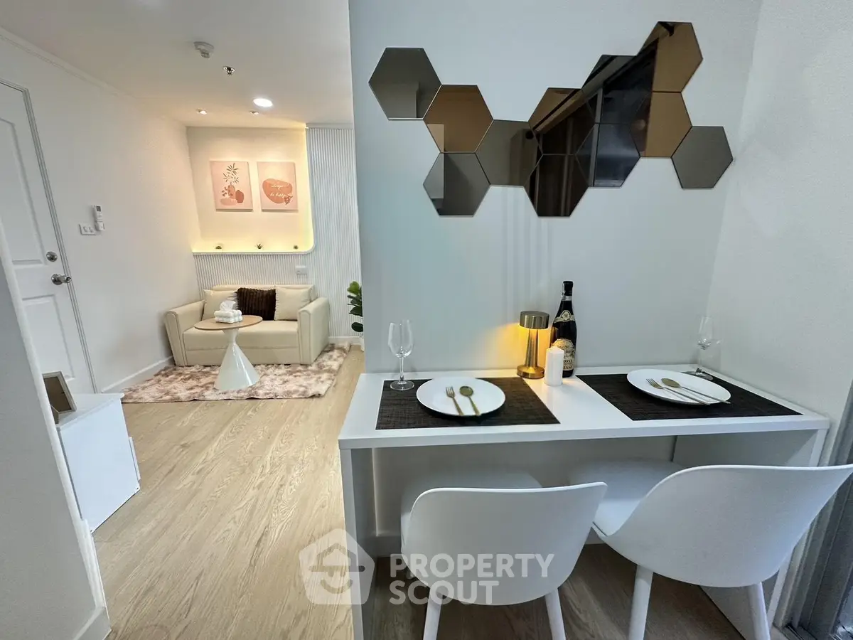 Modern apartment interior with stylish dining area and cozy living room, featuring contemporary decor and warm lighting.