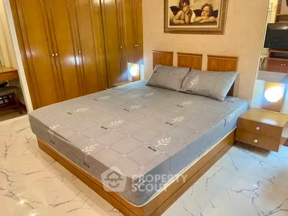 Spacious bedroom with elegant wooden furniture and cozy lighting