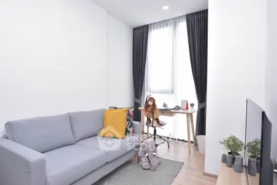 Modern living room with stylish decor and natural light, featuring a cozy sofa and work desk.