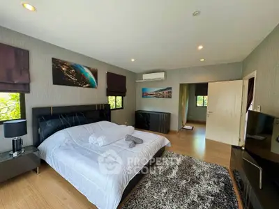 Spacious bedroom with modern decor and natural light