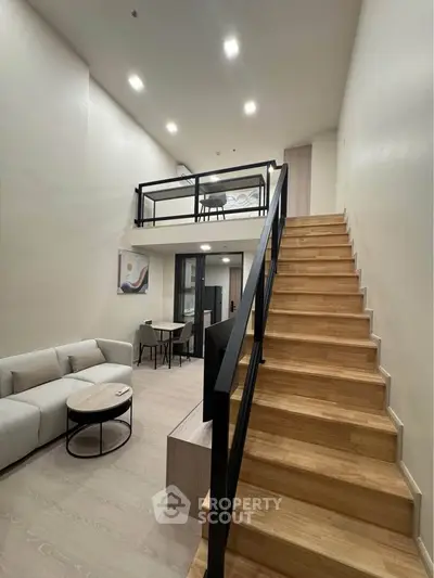 Modern duplex living room with stylish staircase and cozy seating area