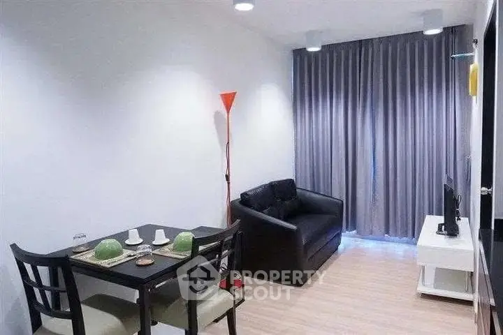 Modern living room with cozy seating and dining area, featuring sleek furniture and stylish decor.