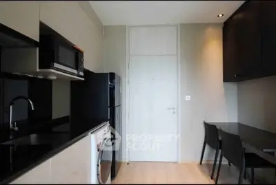 Modern kitchen with sleek appliances and compact dining area