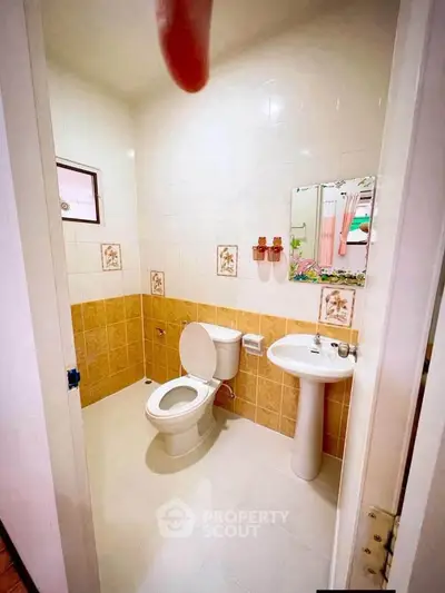 Charming bathroom with classic tile design and modern fixtures, perfect for a cozy home.