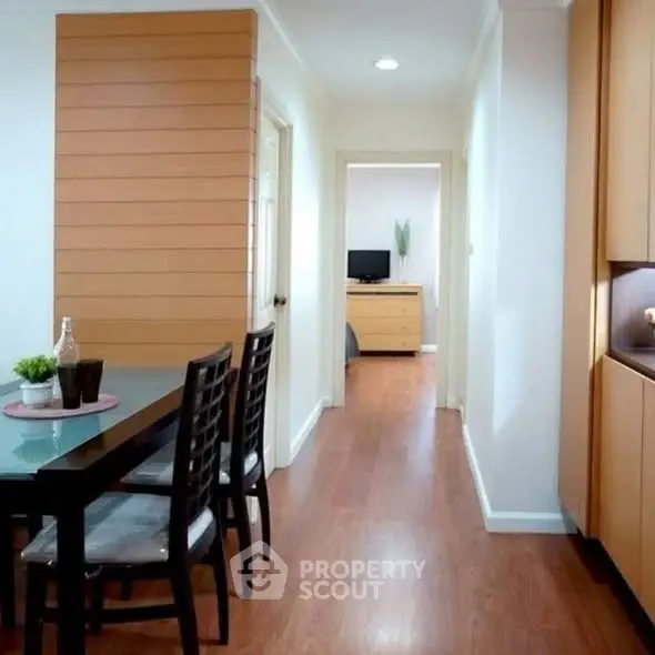Modern dining area with wooden flooring and sleek furniture