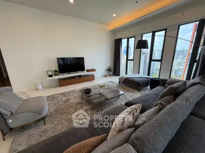 Spacious modern living room with city view, featuring stylish furniture and large windows.