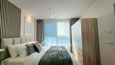 Modern bedroom with stylish decor and ample natural light