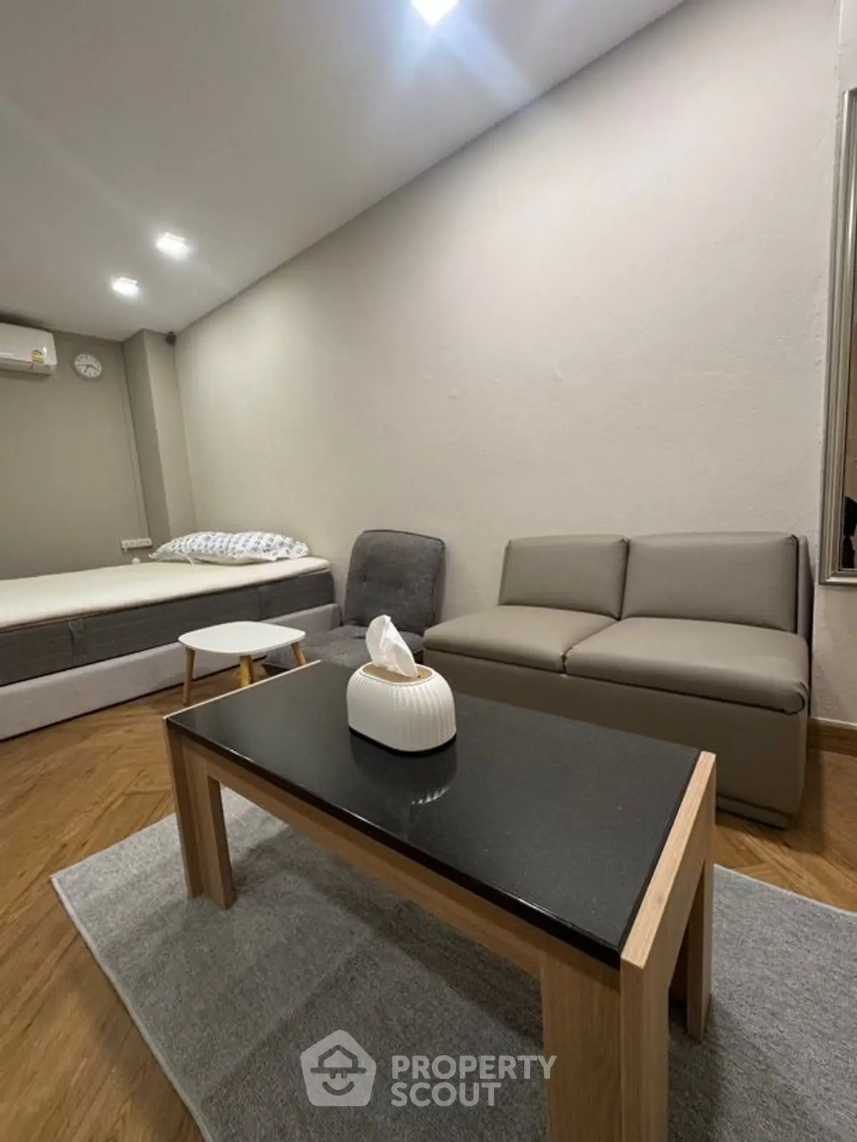 Modern living room with sleek furniture and cozy ambiance, featuring a stylish coffee table and comfortable seating.