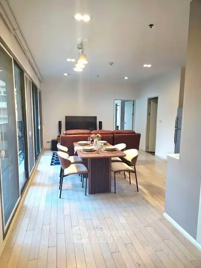 Spacious modern living room with elegant dining area and natural light.
