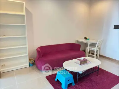 Modern living room with vibrant pink sofa and minimalist decor