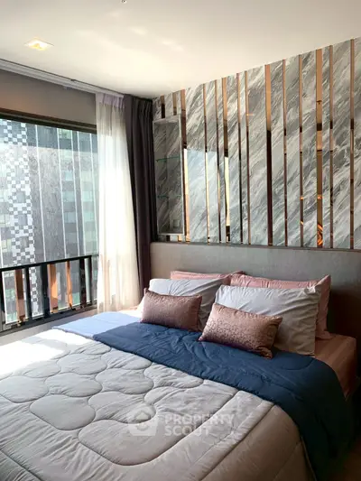 Luxurious bedroom with modern decor and large window offering city view