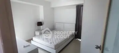 Modern minimalist bedroom with white furniture and natural light