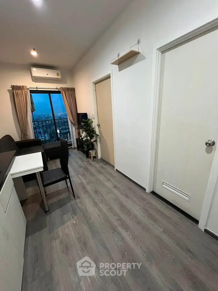 Modern apartment interior with city view, featuring sleek flooring and stylish furniture.