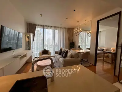 Luxurious open-plan living room with modern decor and city view, featuring elegant lighting and cozy seating area.