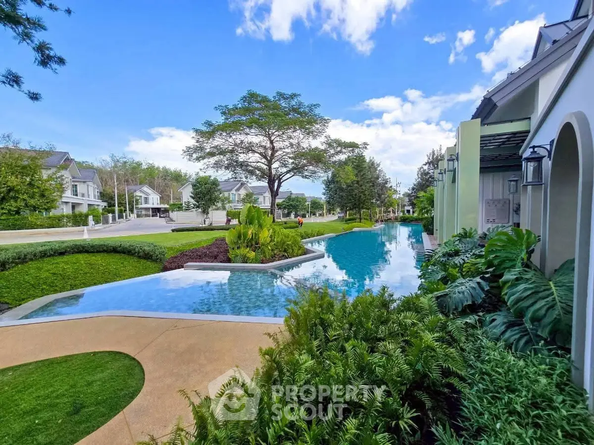 Luxurious residential community with stunning pool and lush greenery, perfect for serene living.