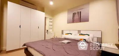 Cozy bedroom with modern wardrobe and stylish decor, perfect for relaxation.