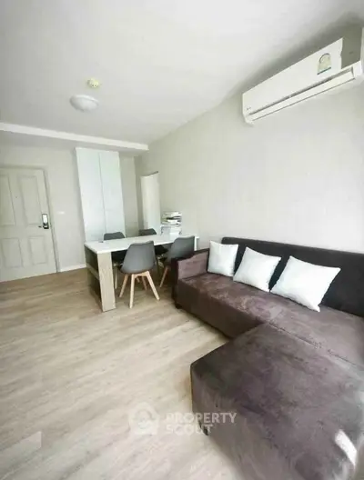 Modern living room with sleek furniture and air conditioning in a stylish apartment.