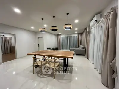 Spacious modern living room with elegant lighting and stylish furniture.