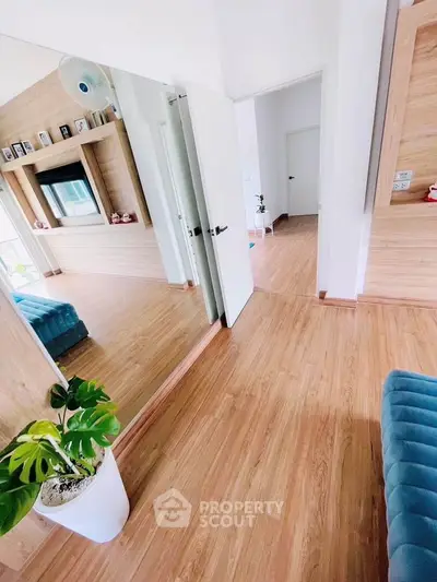 Spacious modern living room with wooden flooring and stylish decor