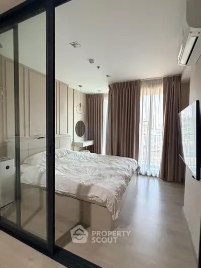 Modern bedroom with large windows and elegant decor in a stylish apartment.