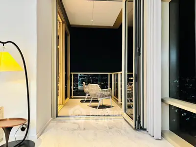 Luxurious high-rise apartment with stunning city view from spacious balcony.